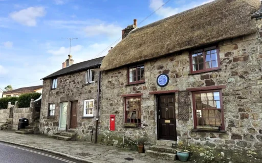 Bob Fitzsimmons’ childhood home, a charming Grade II listed cottage in Helston, Cornwall, is now for sale at £220,000, offering history, modern updates, and a serene garden.