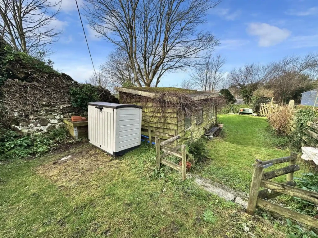 Bob Fitzsimmons’ childhood home, a charming Grade II listed cottage in Helston, Cornwall, is now for sale at £220,000, offering history, modern updates, and a serene garden.