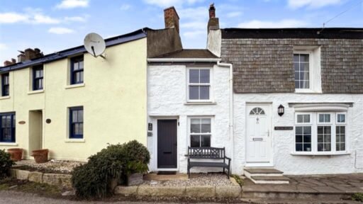 One of Britain's narrowest homes, The Doll's House in Porthleven, Cornwall, is for sale at £235,000 - offering stunning sea views and a charming coastal retreat.