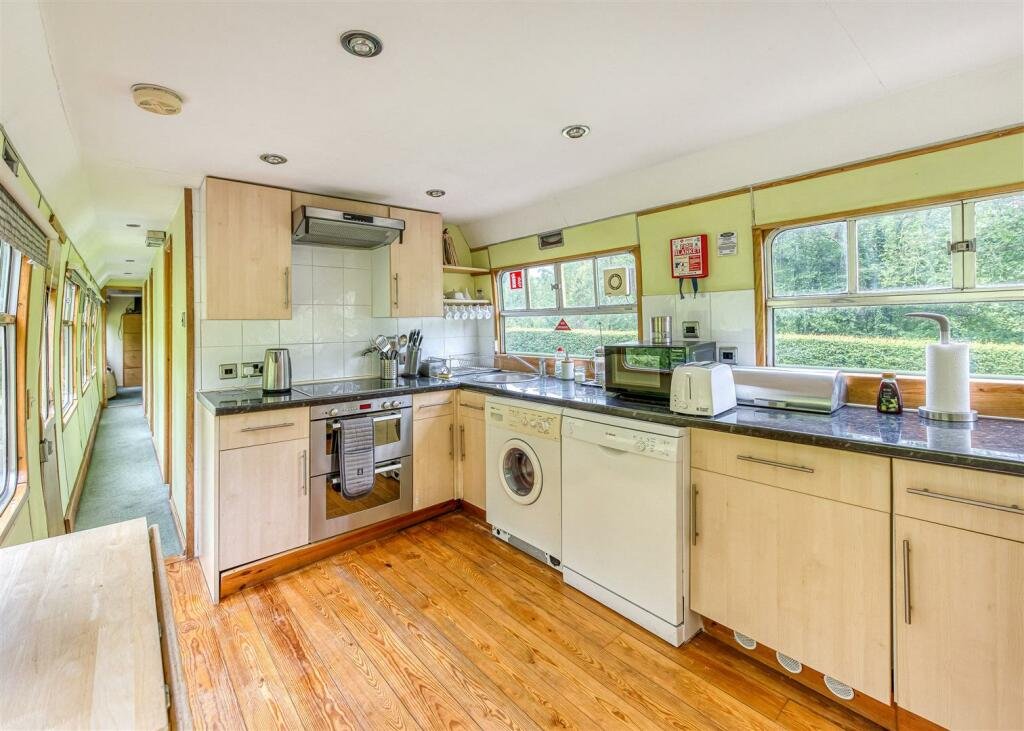 A converted Victorian railway station with vintage train carriages is for sale in Shropshire for £975,000 - a unique home and business earning £45,000 in 10 weeks.