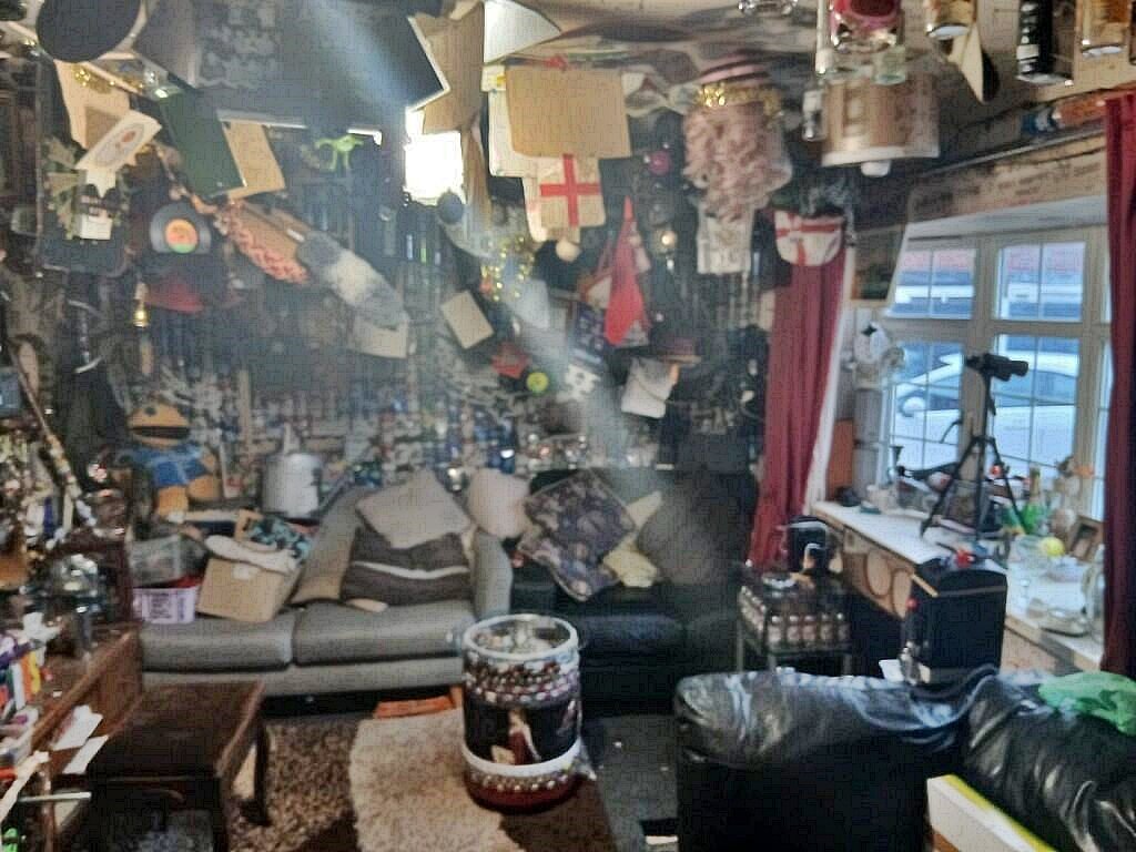 Bizarre UK home with beer can walls hits the market for £185K - featuring Fosters, Stella, and wine bottle decor. See inside this one-of-a-kind property.