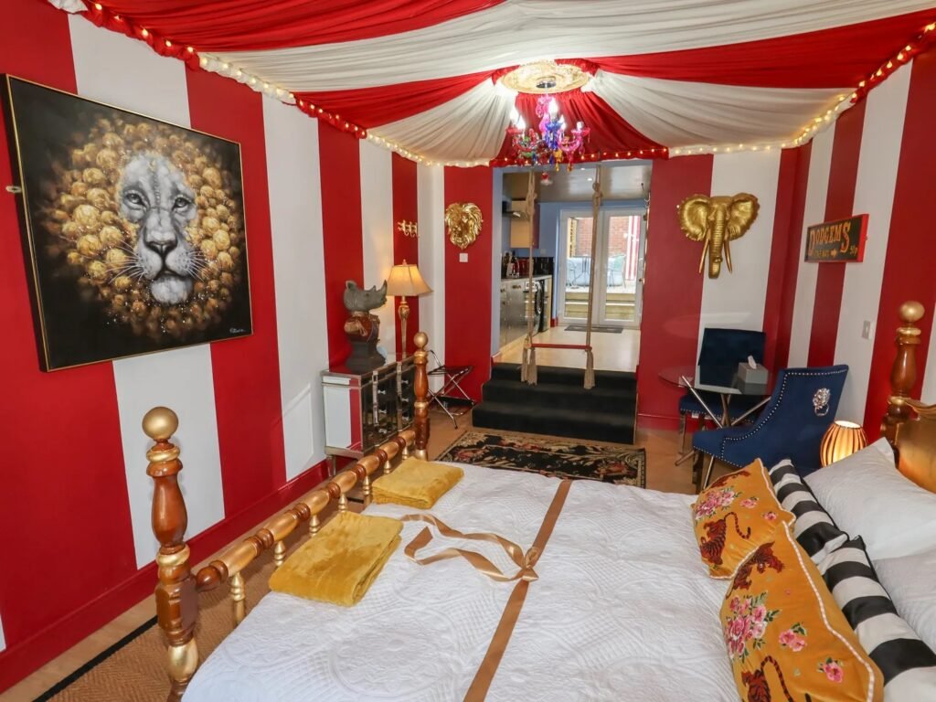 A retired nurse transformed a holiday home in Wales into a circus-themed retreat, complete with striped walls and vintage décor, delighting guests with its playful charm.