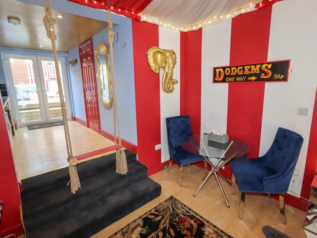 A retired nurse transformed a holiday home in Wales into a circus-themed retreat, complete with striped walls and vintage décor, delighting guests with its playful charm.