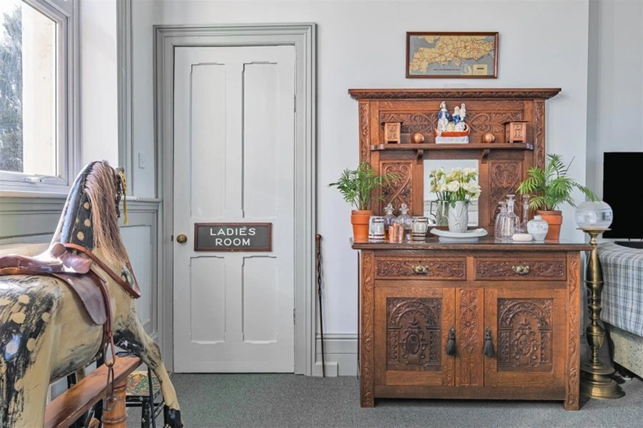 A former village train station in Devon has been transformed into a stunning four-bedroom home, complete with platform and track, now for sale at £775,000.