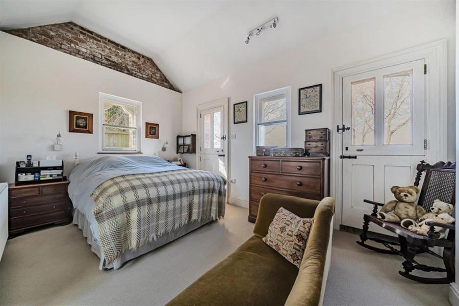 A former village train station in Devon has been transformed into a stunning four-bedroom home, complete with platform and track, now for sale at £775,000.