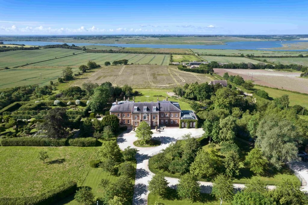 A £20m Georgian-style estate in Essex with 327 acres, indoor pool, vineyard potential and stunning river views offers a dream escape for wine lovers and investors.