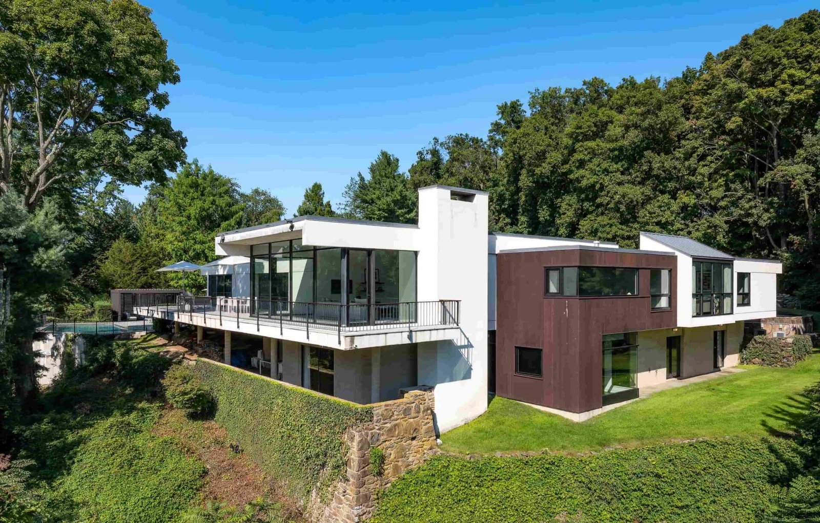 A luxury Rye home redesigned by Yale dean Deborah Berke is on sale for \$4.95m - featuring skylights, a heated pool, spa suite and award-winning architectural design.