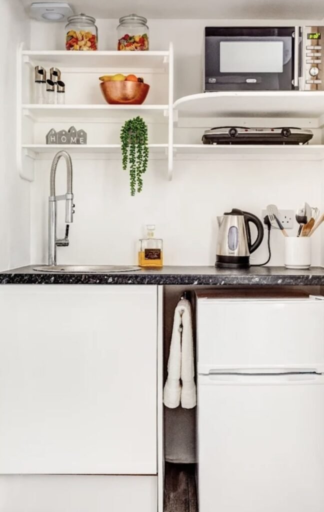 A £900-a-month seafront studio flat in Eastbourne features a kitchen in a cupboard, with a stove, sink and fridge squeezed in, and is only suitable for single tenants.