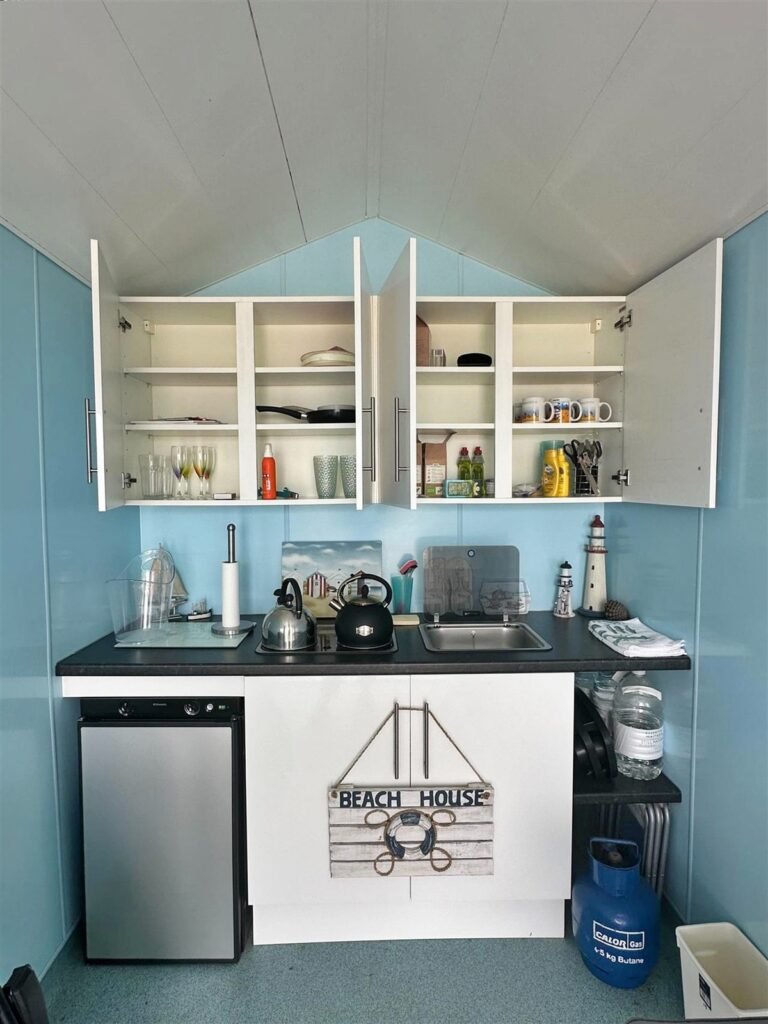 A tiny 13ft beach hut on Avon Beach, Dorset, with sea views and minimal facilities is on sale for £110,000 - offering a private summer spot despite no toilets or showers.