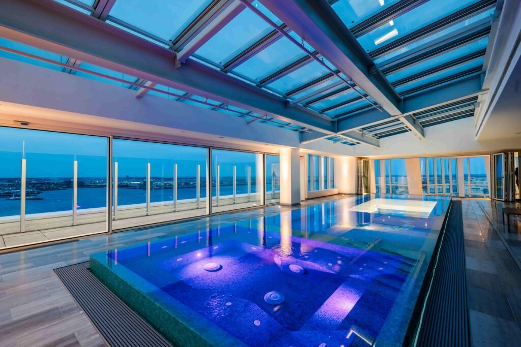 The Grand Penthouse in Boston boasts 10,000 sq ft of opulence, a transparent indoor infinity pool, and could break records with its \$49.5m price tag as Massachusetts’ priciest home.