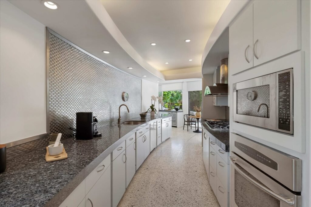 Loretta Young’s glamorous Palm Springs home, a mid-century modern masterpiece with curved walls, origami ceilings and a lush garden, is now listed for just under \$2.5 million.