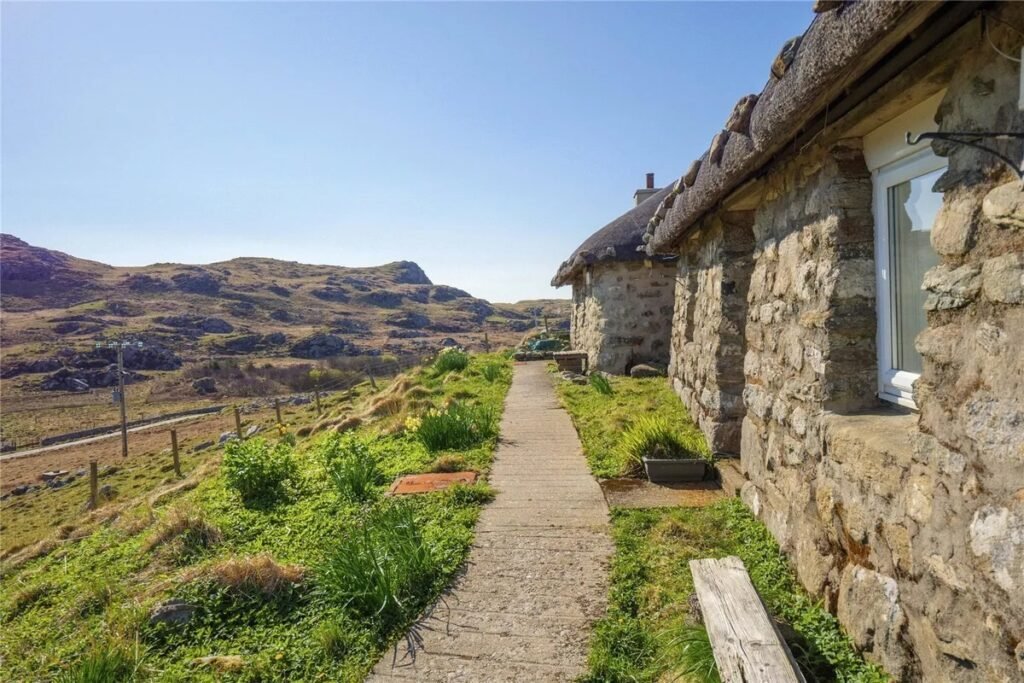 Twin thatched cottages on Scotland's Isle of Coll are for sale at £420,000, offering ocean views, shared gardens and rustic charm near where Kate Winslet owns a home.