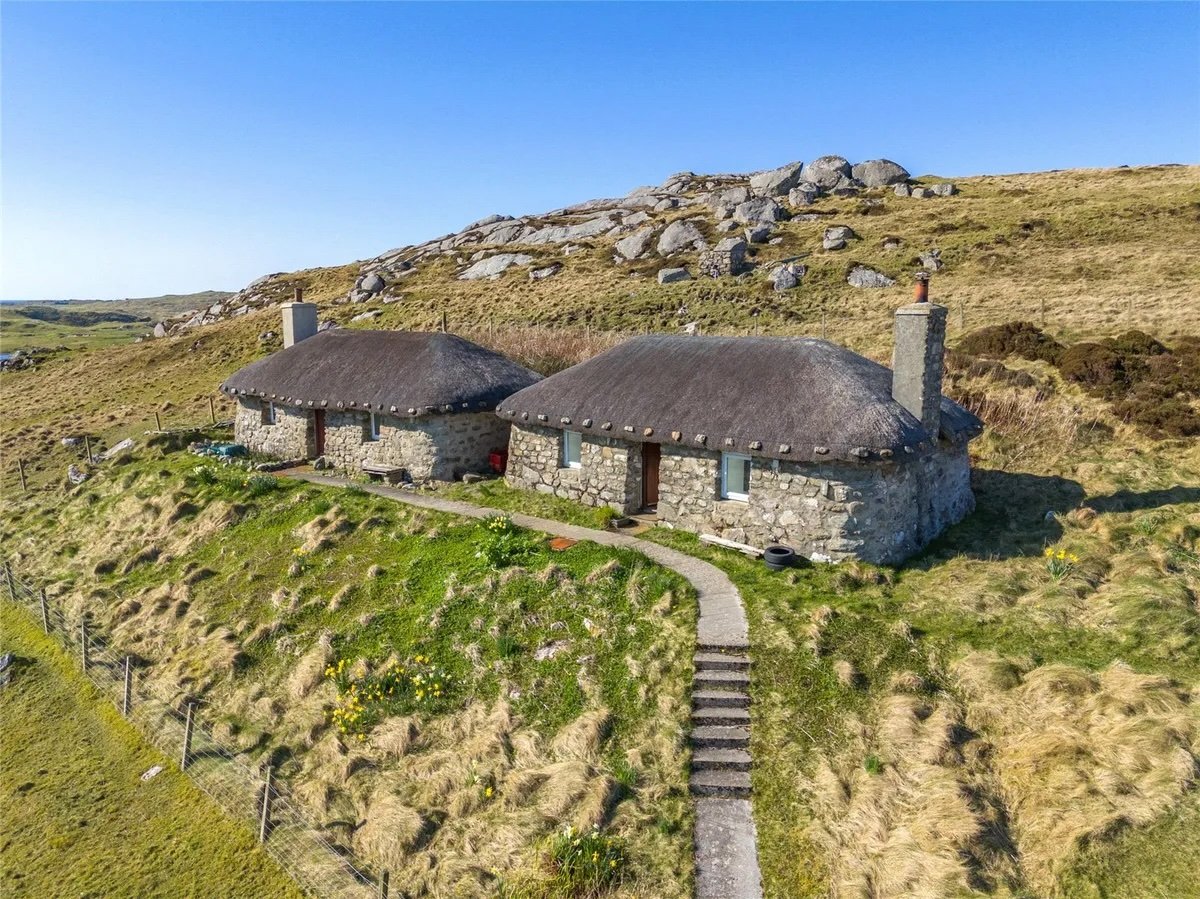 Twin thatched cottages on Scotland's Isle of Coll are for sale at £420,000, offering ocean views, shared gardens and rustic charm near where Kate Winslet owns a home.