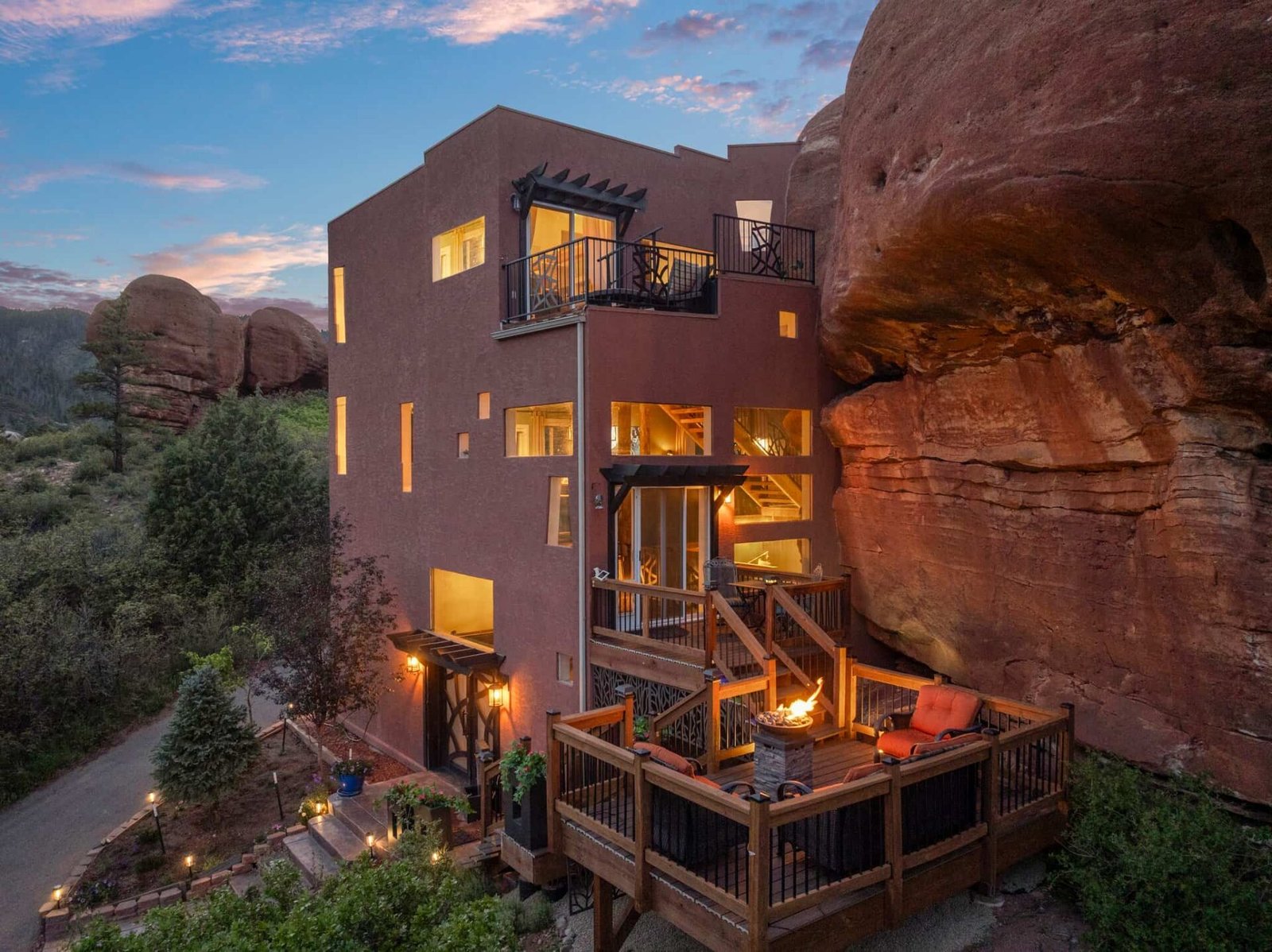 The \$1 million Rock House in Colorado blends nature and design, built into a 45-foot red rock monolith with dramatic views, unique interiors and prehistoric charm.