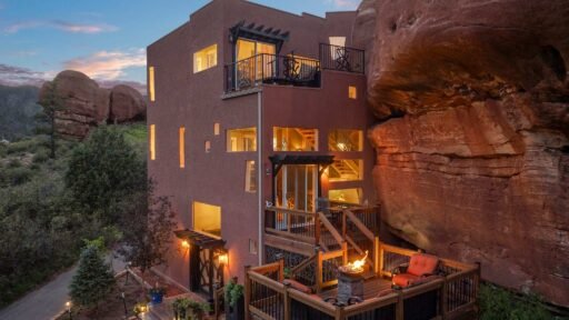 The \$1 million Rock House in Colorado blends nature and design, built into a 45-foot red rock monolith with dramatic views, unique interiors and prehistoric charm.