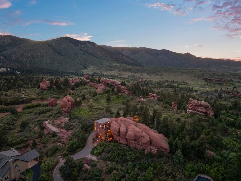 The \$1 million Rock House in Colorado blends nature and design, built into a 45-foot red rock monolith with dramatic views, unique interiors and prehistoric charm.