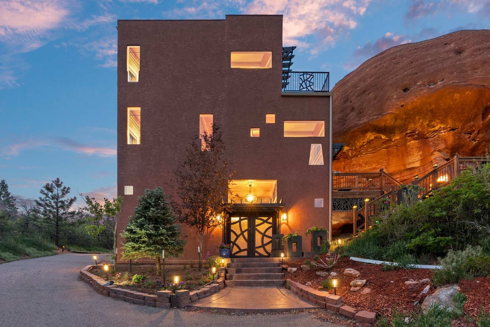 The \$1 million Rock House in Colorado blends nature and design, built into a 45-foot red rock monolith with dramatic views, unique interiors and prehistoric charm.