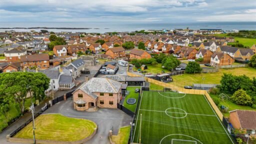 A five-bed Northern Ireland home with a full-size seven-a-side football pitch, gym, dog shower and luxe interiors is on sale for £435,000 offering fun and privacy.
