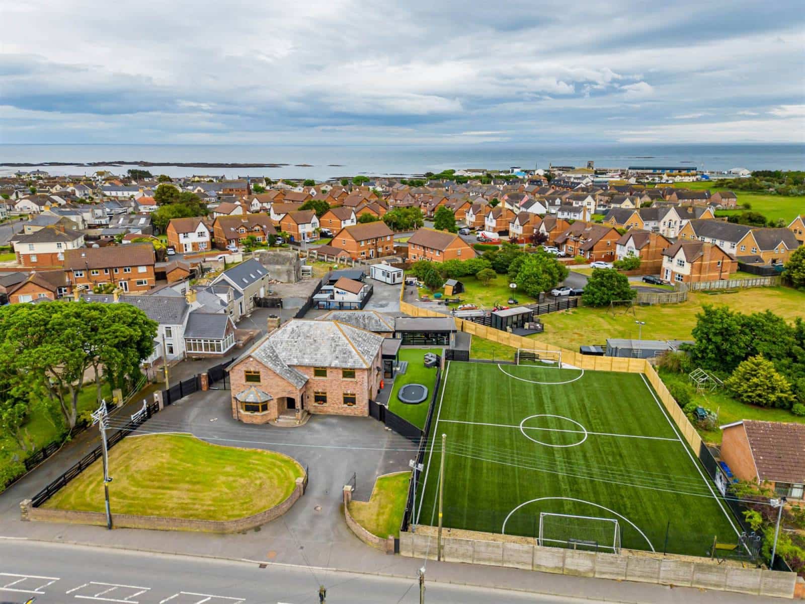 A five-bed Northern Ireland home with a full-size seven-a-side football pitch, gym, dog shower and luxe interiors is on sale for £435,000 offering fun and privacy.