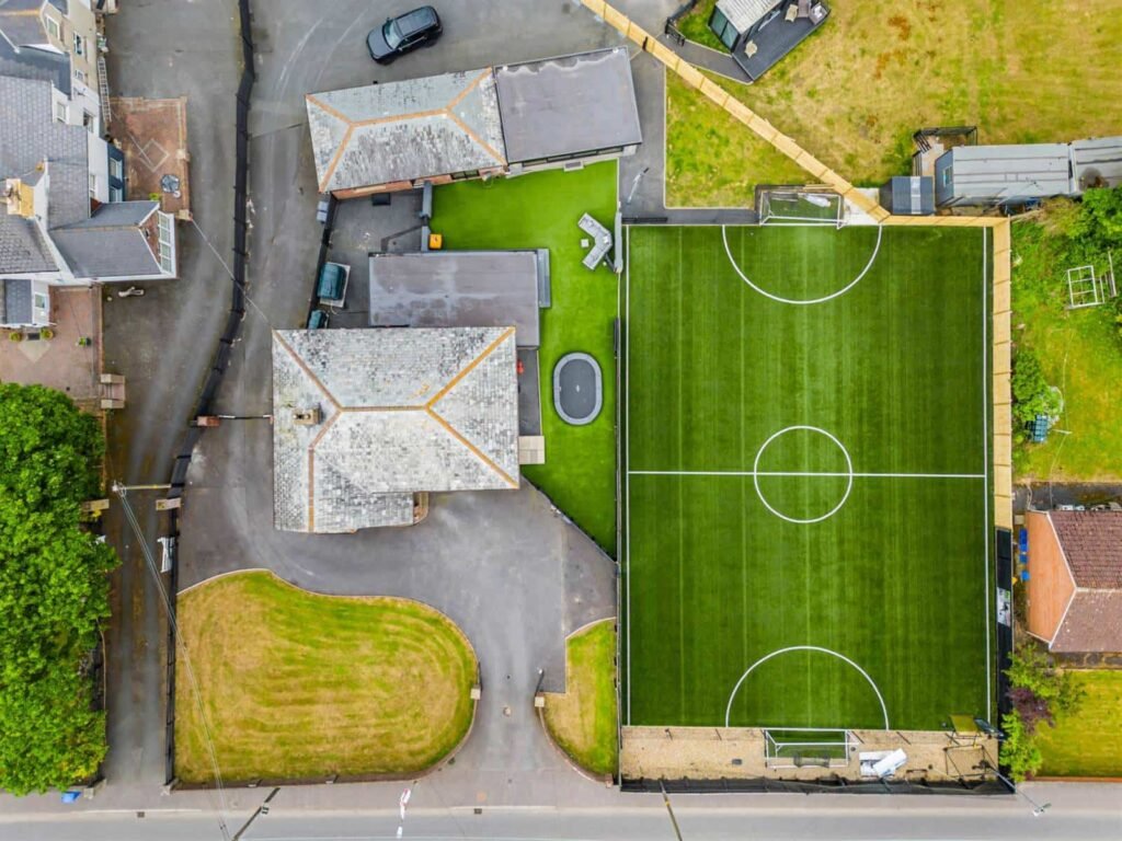 A five-bed Northern Ireland home with a full-size seven-a-side football pitch, gym, dog shower and luxe interiors is on sale for £435,000 offering fun and privacy.