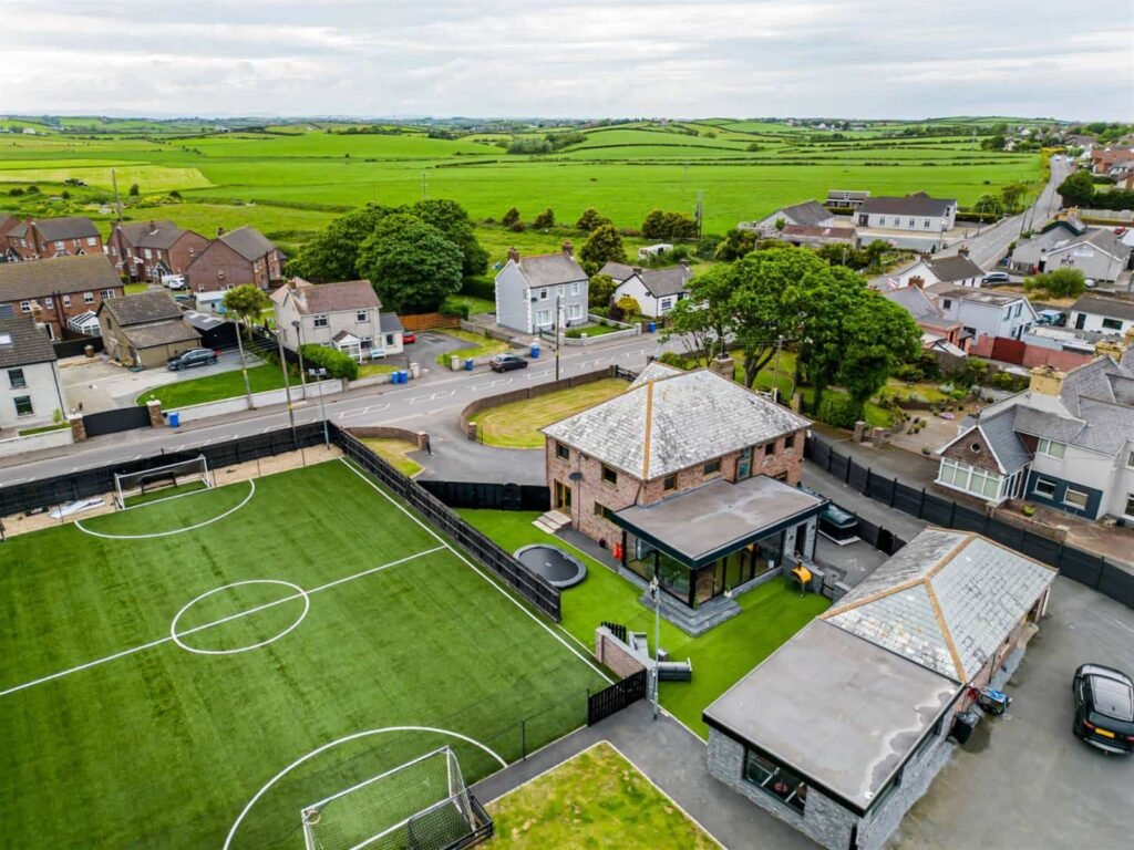 A five-bed Northern Ireland home with a full-size seven-a-side football pitch, gym, dog shower and luxe interiors is on sale for £435,000 offering fun and privacy.