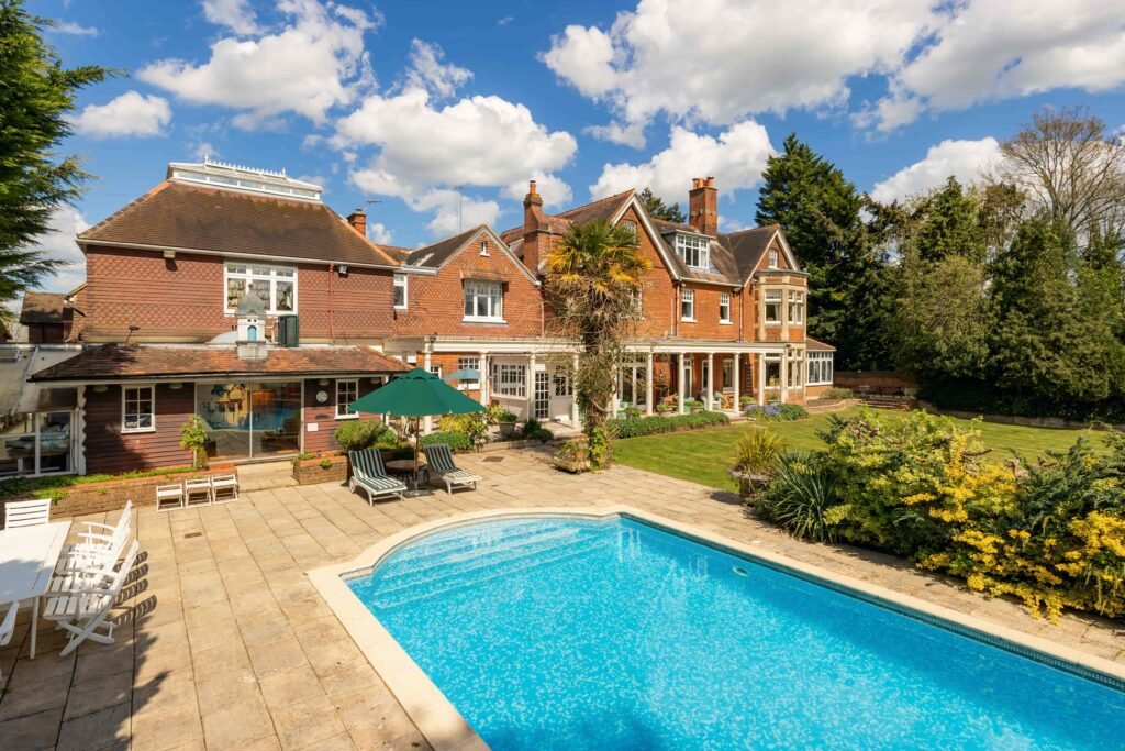 Stanley Kubrick’s former Elstree mansion with a pool, lush gardens, and film history is for sale at £6.95m, just in time for London’s sizzling summer heatwave.