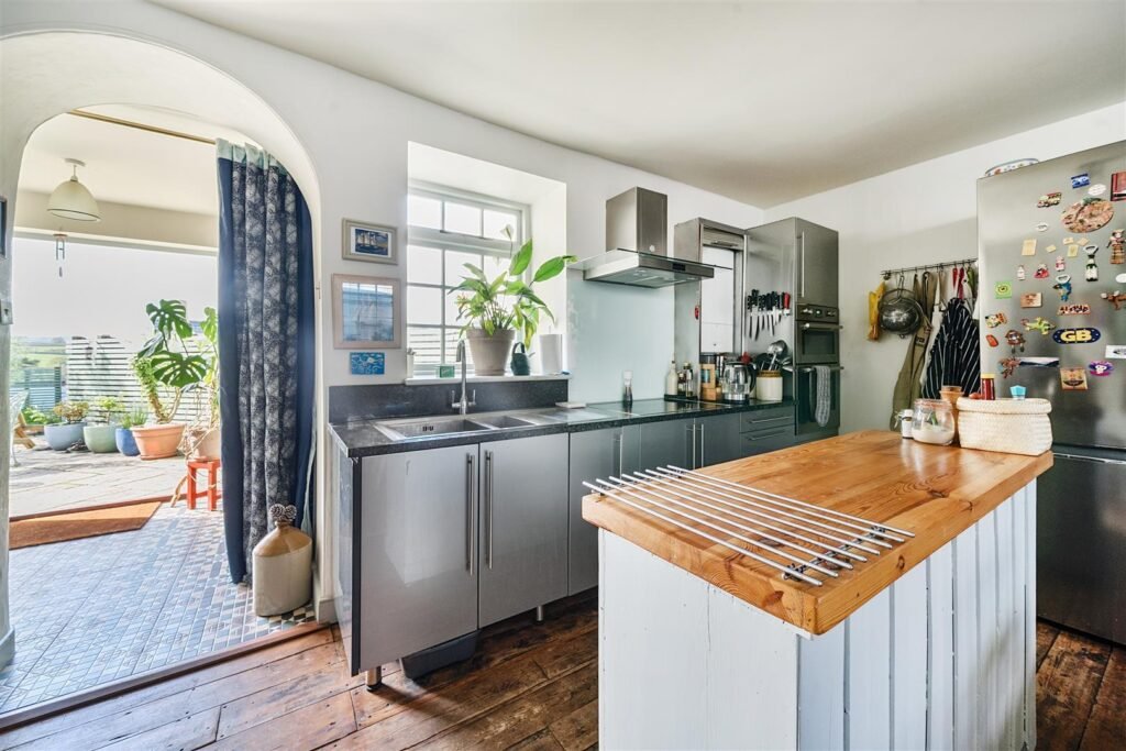 A Georgian townhouse in Devon with a secret tunnel, wine store, and historic well is on the market for £475,000, offering charm, character, and a touch of mystery.
