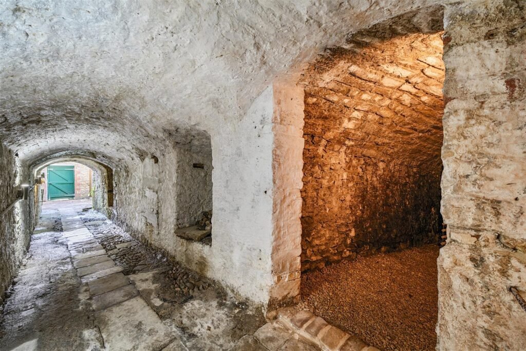 A Georgian townhouse in Devon with a secret tunnel, wine store, and historic well is on the market for £475,000, offering charm, character, and a touch of mystery.