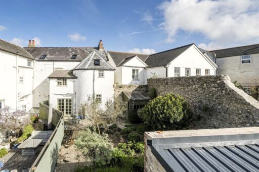 A Georgian townhouse in Devon with a secret tunnel, wine store, and historic well is on the market for £475,000, offering charm, character, and a touch of mystery.
