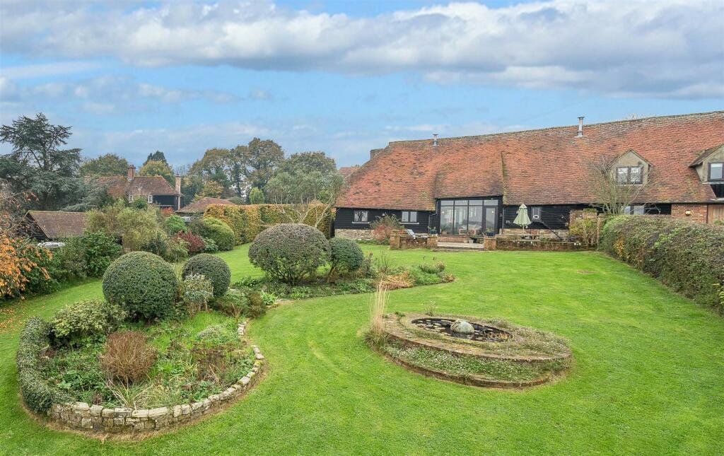 This £945k East Sussex barn home has 3 beds, a vineyard, 12.5 acres, stunning valley views and its own private airstrip and hangar for microlight aircraft.