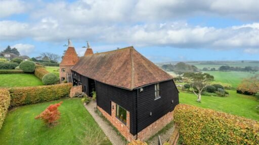 This £945k East Sussex barn home has 3 beds, a vineyard, 12.5 acres, stunning valley views and its own private airstrip and hangar for microlight aircraft.