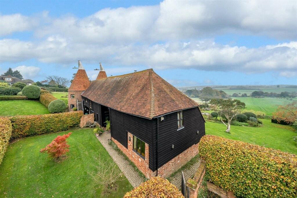 This £945k East Sussex barn home has 3 beds, a vineyard, 12.5 acres, stunning valley views and its own private airstrip and hangar for microlight aircraft.