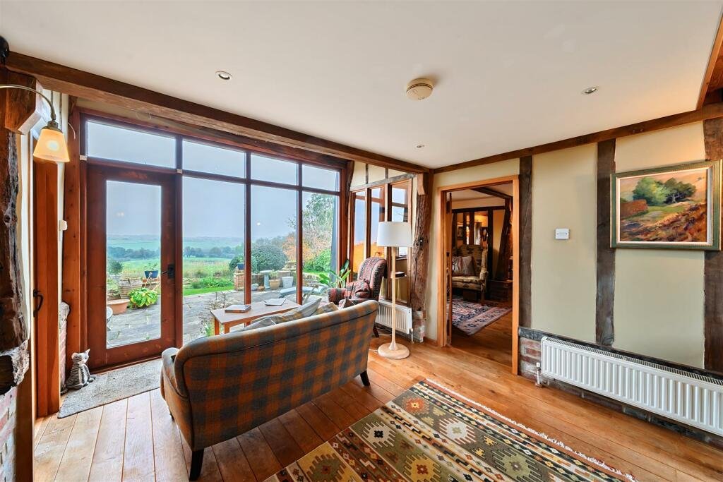 This £945k East Sussex barn home has 3 beds, a vineyard, 12.5 acres, stunning valley views and its own private airstrip and hangar for microlight aircraft.