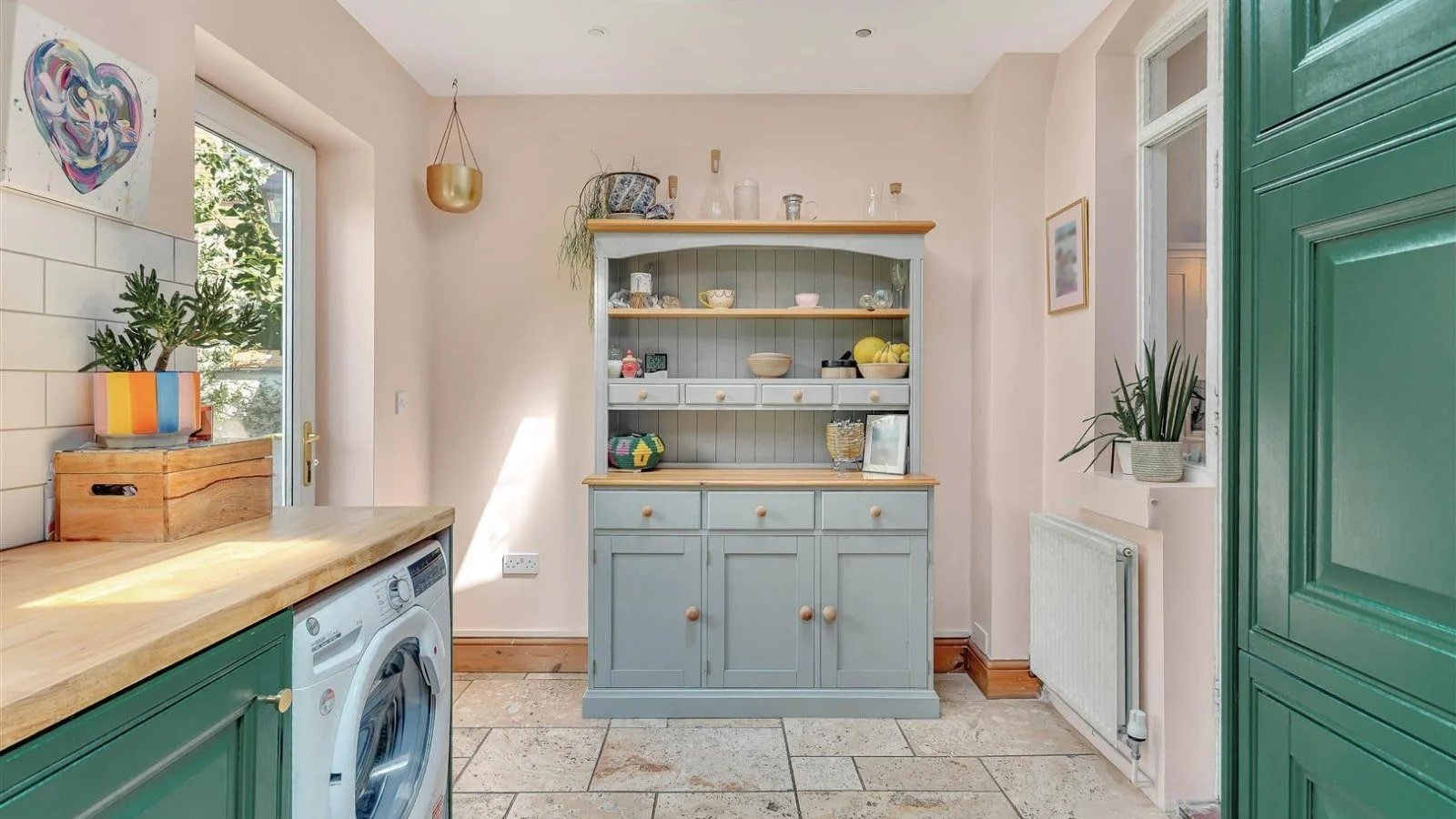 A Victorian semi in Bedford with three bedrooms, a stylish courtyard, and a fully equipped salon outbuilding is on sale for £450,000 offering charm and versatility.