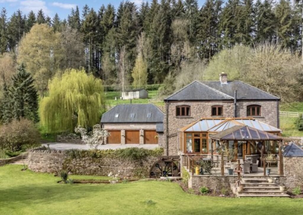 A £1.5m riverside home in Wales with a working water wheel, lush gardens, fishing rights and a two-bed annexe offers luxury countryside living on nearly 14 acres.