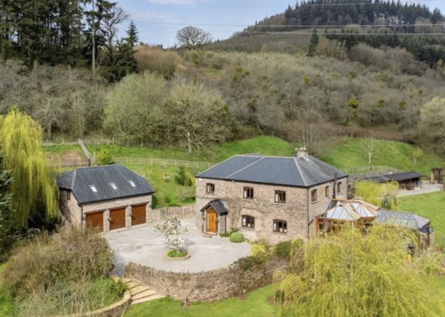 A £1.5m riverside home in Wales with a working water wheel, lush gardens, fishing rights and a two-bed annexe offers luxury countryside living on nearly 14 acres.