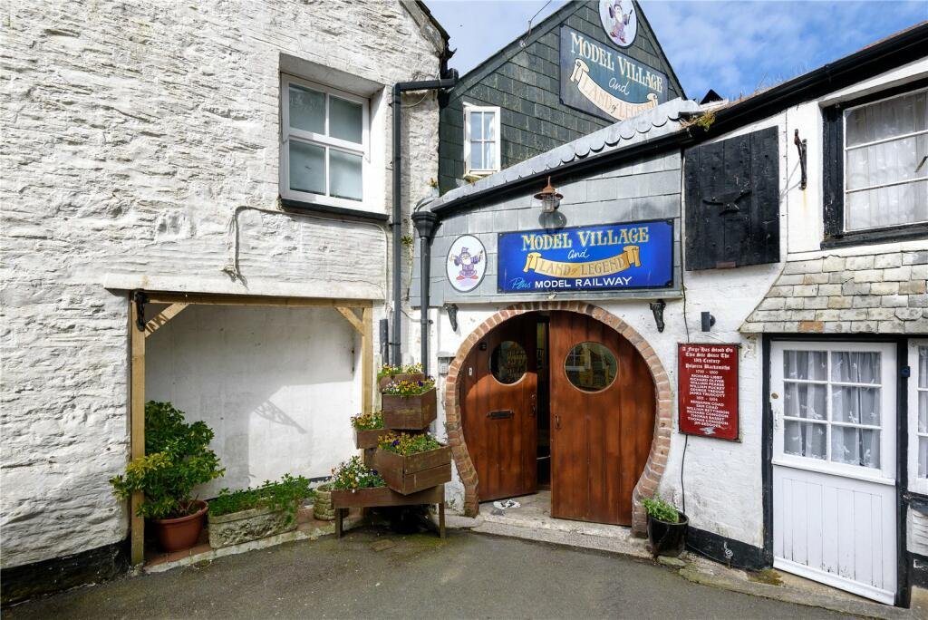 A detailed model village in scenic Polperro, Cornwall is for sale at £710k including a 3-bed home, mini harbour, railway and folklore exhibit attracting thousands yearly.