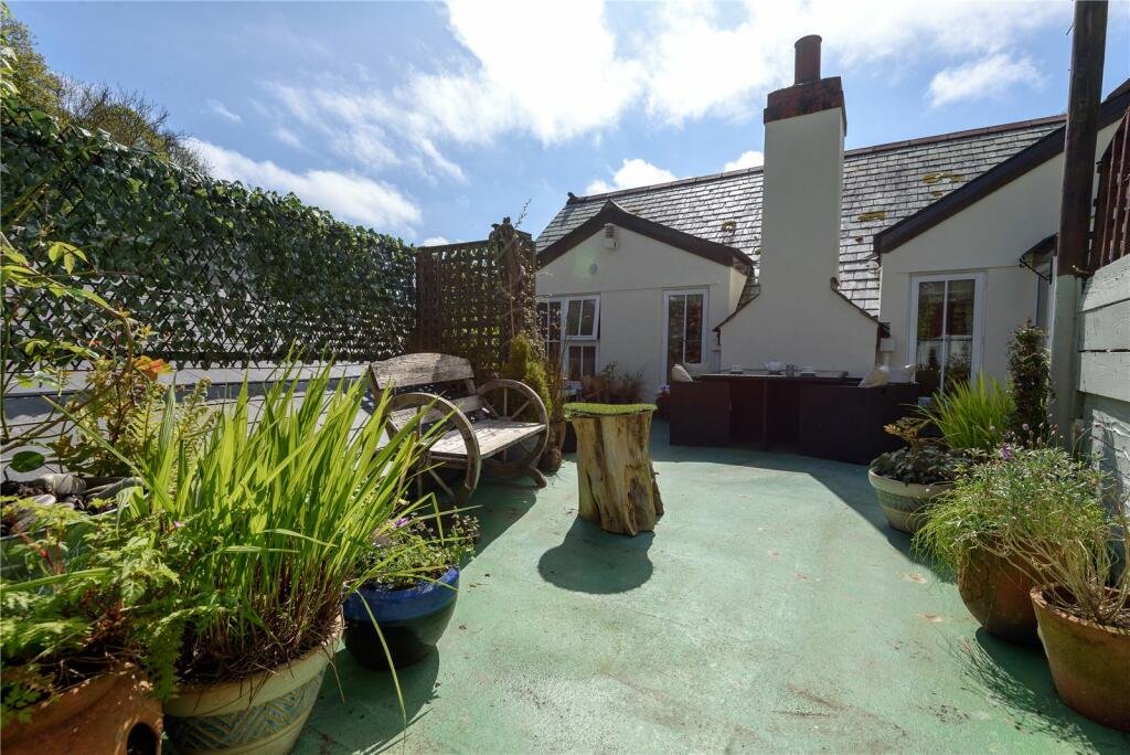 A detailed model village in scenic Polperro, Cornwall is for sale at £710k including a 3-bed home, mini harbour, railway and folklore exhibit attracting thousands yearly.