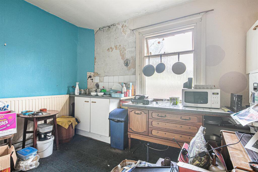 Snap up a three-bed Sheffield home with huge potential for just £130K. It’s packed with clutter and mold, but comes with a vintage retail unit and prime location.