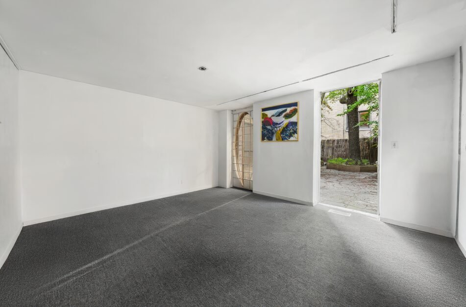 An iconic New York bubble house in Lenox Hill is on the market for \$5.75M, boasting curved glass windows, minimalist interiors, and a lush walled garden.