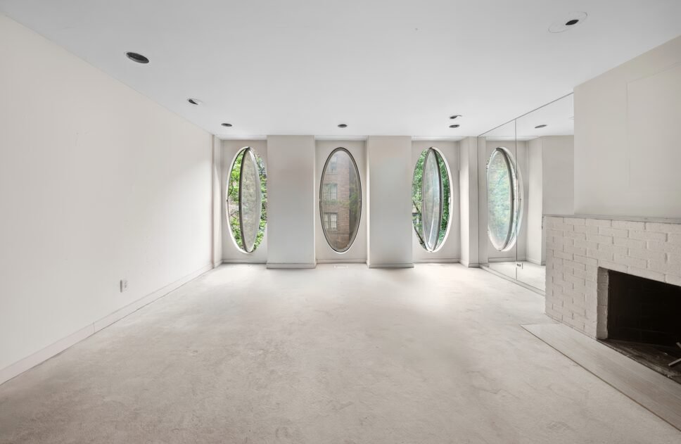 An iconic New York bubble house in Lenox Hill is on the market for \$5.75M, boasting curved glass windows, minimalist interiors, and a lush walled garden.