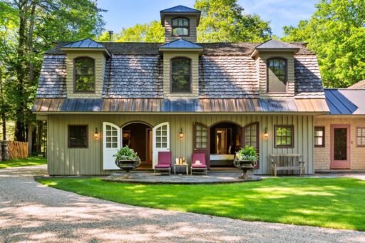 A \$3.25m Massachusetts estate features a quarry-carved pool with a 16ft waterfall, lush gardens, a canopy porch, and serene luxury across 3,459 sq ft of private grounds.