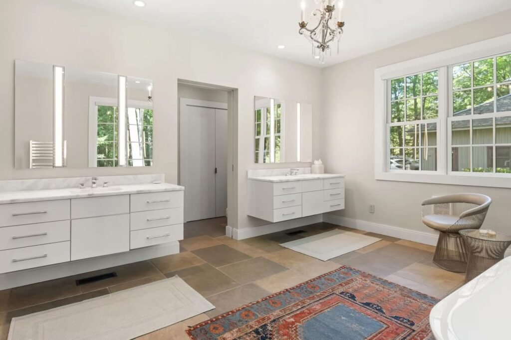 A \$3.25m Massachusetts estate features a quarry-carved pool with a 16ft waterfall, lush gardens, a canopy porch, and serene luxury across 3,459 sq ft of private grounds.