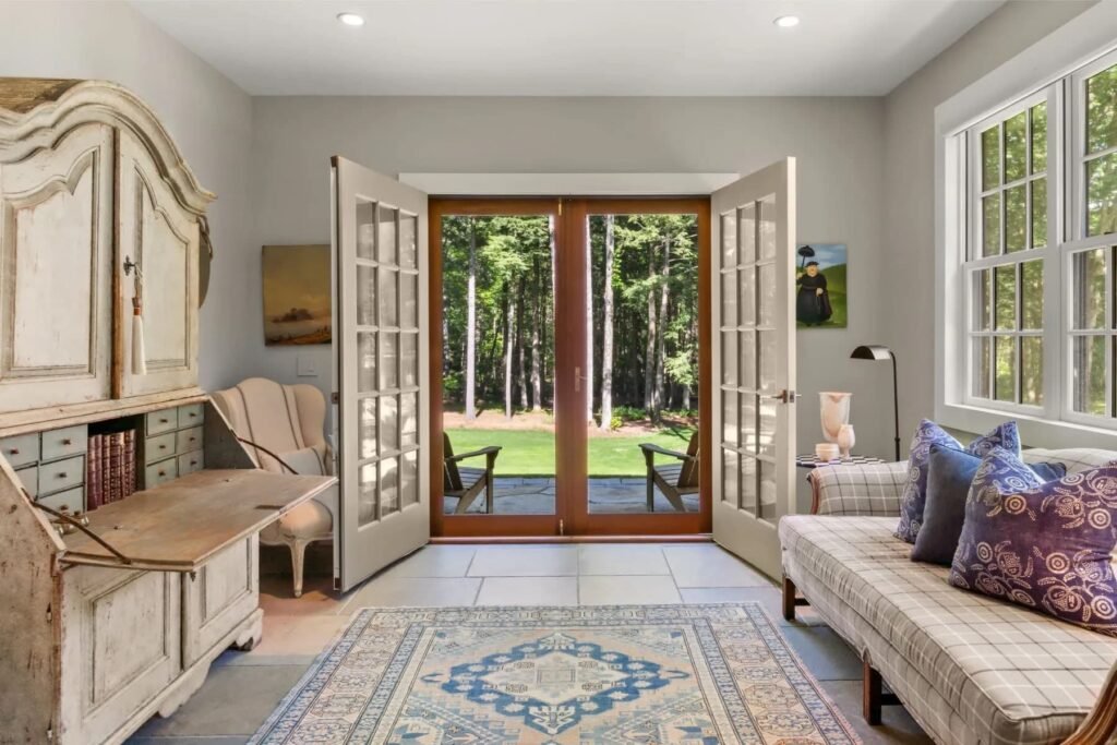 A \$3.25m Massachusetts estate features a quarry-carved pool with a 16ft waterfall, lush gardens, a canopy porch, and serene luxury across 3,459 sq ft of private grounds.