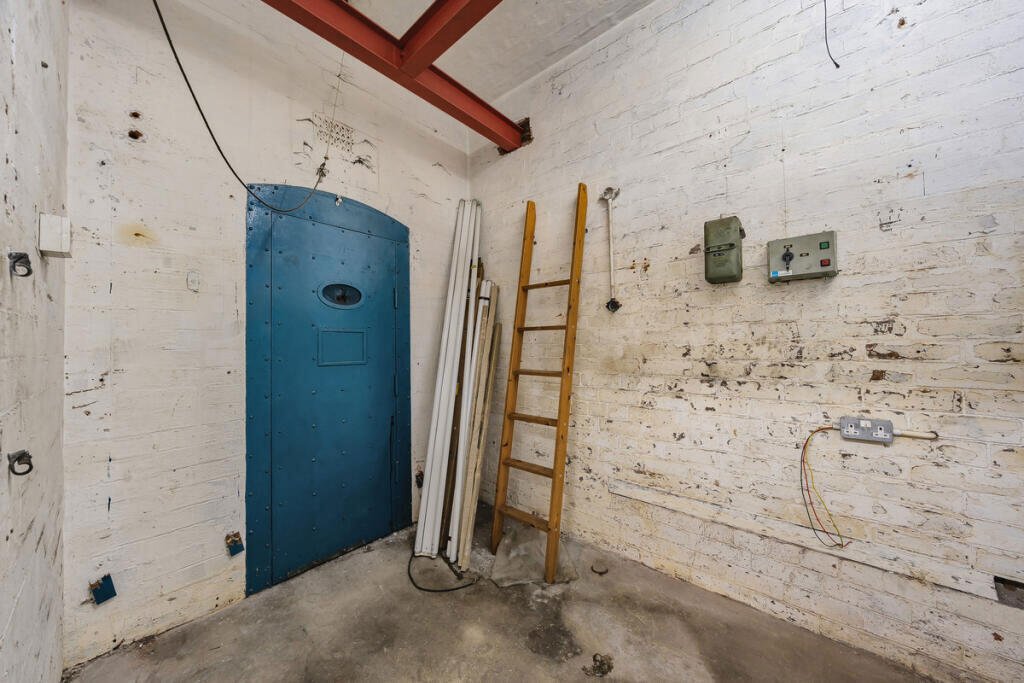 A historic 1887 police station in Marple with its own cell is for sale at £165,000, offering planning approval to convert it into a unique two-bedroom character home.