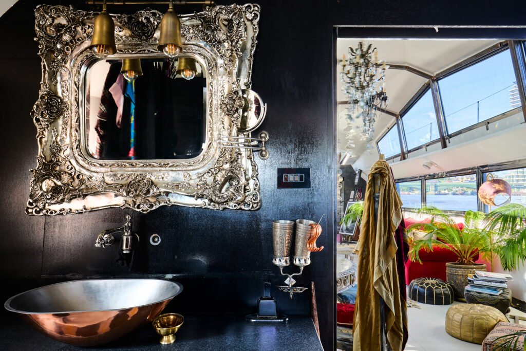 A £1.15m floating sculpture moored in Fulham, Wonderland is a mirrored grain barge turned bohemian home with chandeliers, Thames views and historic artistic charm.