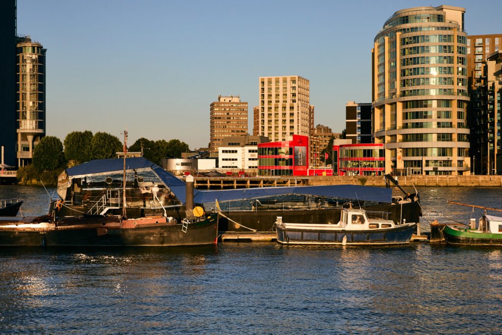 A £1.15m floating sculpture moored in Fulham, Wonderland is a mirrored grain barge turned bohemian home with chandeliers, Thames views and historic artistic charm.