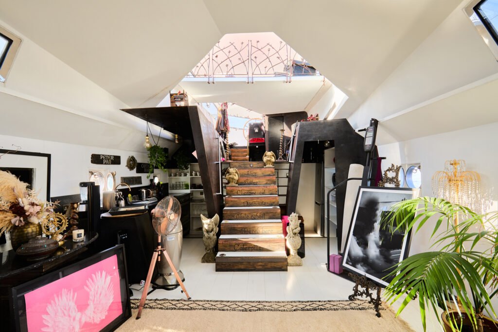 A £1.15m floating sculpture moored in Fulham, Wonderland is a mirrored grain barge turned bohemian home with chandeliers, Thames views and historic artistic charm.