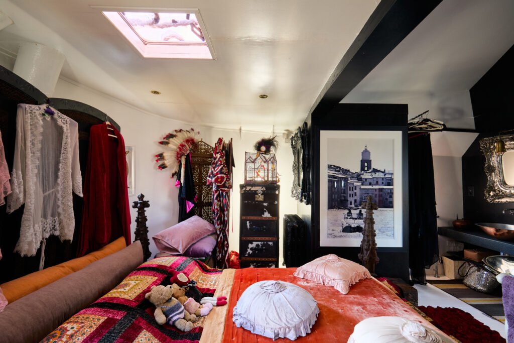 A £1.15m floating sculpture moored in Fulham, Wonderland is a mirrored grain barge turned bohemian home with chandeliers, Thames views and historic artistic charm.