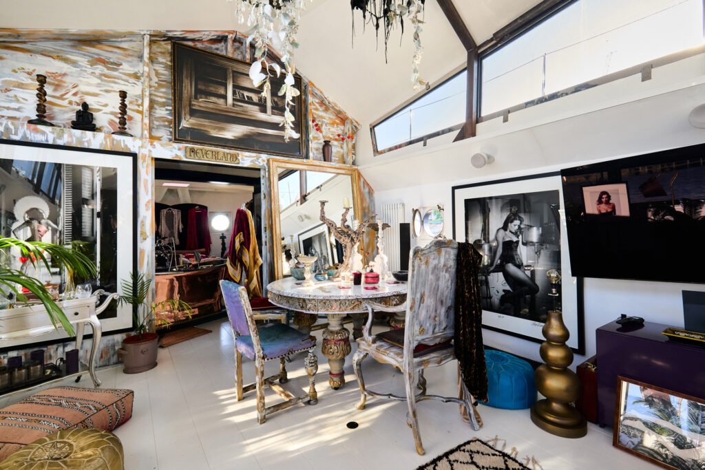 A £1.15m floating sculpture moored in Fulham, Wonderland is a mirrored grain barge turned bohemian home with chandeliers, Thames views and historic artistic charm.